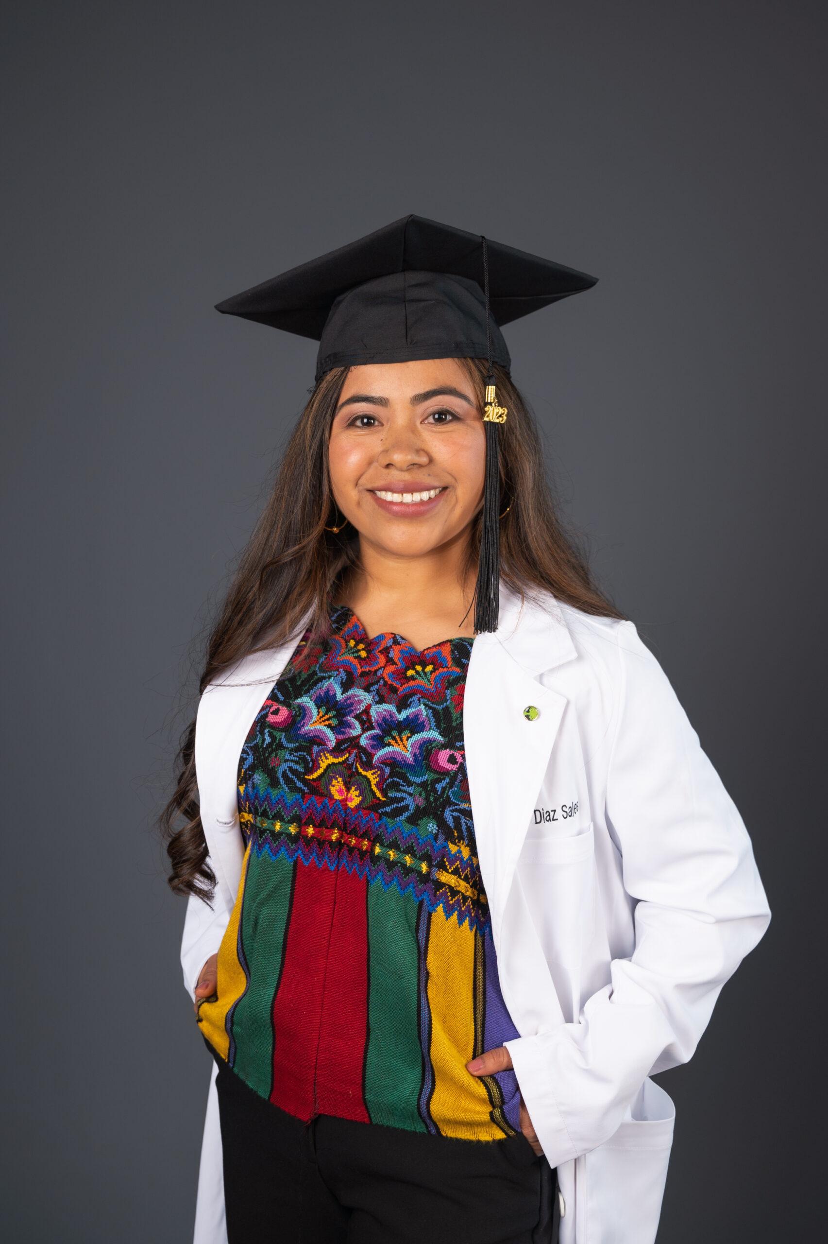 Jenny Sales in coat and graduation cap